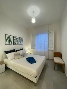 a bedroom with a bed with a blue towel on it at Nerea in San Vito lo Capo