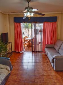 a living room with a couch and a table at MAXIMAR Apartment 8 bed places, heated swimmingpool in Arona