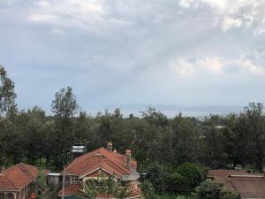 a group of houses with trees in the background at Mt zion penthouse in Lake View Estate