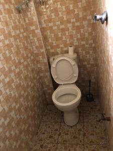 a small bathroom with a toilet in a stall at Mt zion penthouse in Lake View Estate