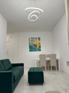 a living room with a green couch and a table at Apartments Sea Side in Petrovac na Moru