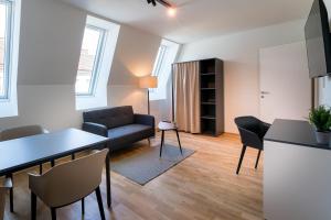 a living room with a couch and a table at Vienna Residence, Prater - Exhibition Center in Vienna