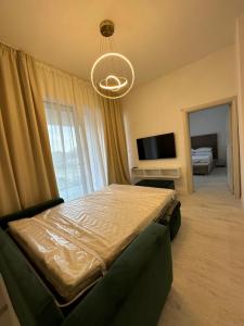 a bedroom with a bed and a chandelier at Apartments Sea Side in Petrovac na Moru