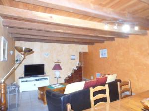 a living room with a couch and a television at location thezacaise in Thézac