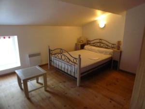 a bedroom with a bed and a table in it at location thezacaise in Thézac