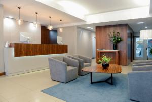 a lobby with chairs and a table and a counter at Hotel Navarras in Amarante +44 photos