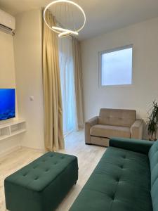 a living room with a couch and a tv at Apartments Sea Side in Petrovac na Moru