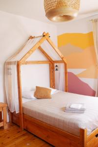 a bedroom with a wooden bed with a canopy at La Secousse in La Malbaie +42 photos