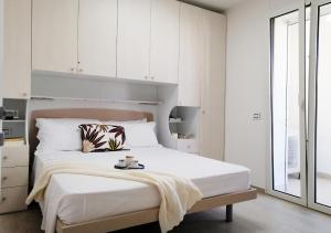 Ένα ή περισσότερα κρεβάτια σε δωμάτιο στο Holihome - Appartamento LA GIOIA