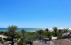 a view of the beach from the balcony of a resort at Apartment Vicente in Vilanova i la Geltrú