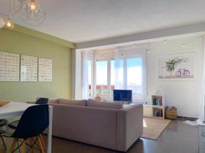 a living room with a couch and a television at Apartment Vicente in Vilanova i la Geltrú