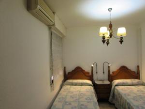 En eller flere senge i et værelse på AGUADULCE BEACH FRoNT