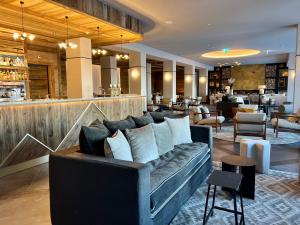 a living room with a couch and a bar at Luxury chalet apartment 4 Valleys in Hérémence