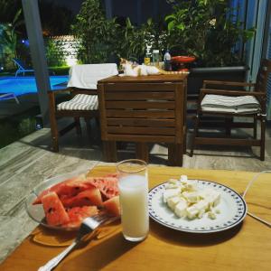 a plate of food on a table with a glass of milk at La Maison de Yasmine in Alaçatı