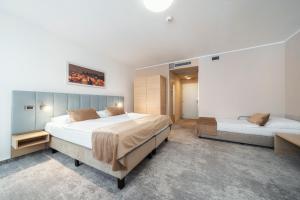 a large bedroom with two beds in it at Hotel Ehrlich Prague in Prague +27 photos