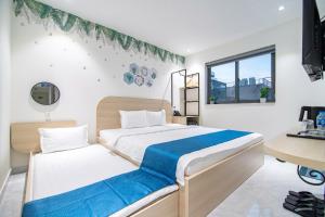 Ένα ή περισσότερα κρεβάτια σε δωμάτιο στο Bin Bin Hotel 14 Near Vstar School D7