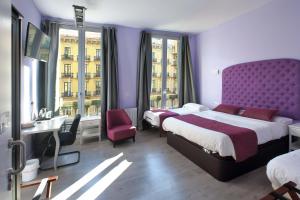 Posteľ alebo postele v izbe v ubytovaní Hotel Ginebra