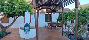 a patio with a gazebo with a fish painted on it at GRAN CASA RURAL CON PATIO EN ENCINAREJO DE CÓRDOBA in Encinarejo De Córdoba