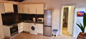 a kitchen with a refrigerator and a washing machine at Casa Joy in Tejina de Isora