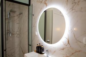 a bathroom with a sink and a mirror at Pries Homes - Little Lotus in Málaga +56 photos