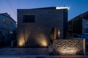 a brick building with lights on the side of it at yado taniguchi in Matsuzaka