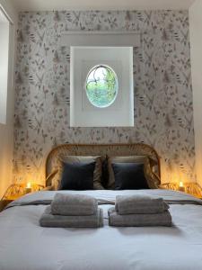 a bedroom with a large bed with two pillows on it at Au cœur de Bourges in Bourges
