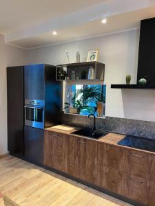 a kitchen with a sink and a stove at Villa Italia in Canzo