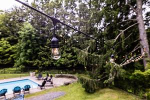 a light hanging from a pole next to a pool at The Jarvis Homestead - Historic Maine Mansion in Ellsworth