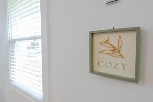 a picture of a butterfly sign on a wall at #StayInMyDistrict Cypress Cottage Coos Bay in Coos Bay +35 photos
