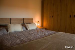 a bedroom with a large bed with two pillows at Casa Garí d'Horta de Sant Joan in Horta de San Joan