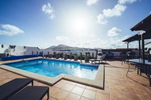 a swimming pool on the roof of a building at Casa Natura in San Bartolomé