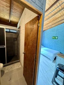 a door leading into a small room with a bed at POSADA MISS ANIBEL in San Andrés