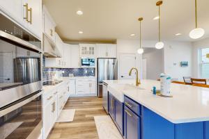 a large kitchen with white cabinets and blue appliances at Marlin Chase in Ocean View