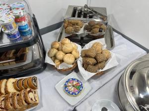 a table topped with baskets of pastries and other foods at Pensjonat Boss zabawa Sylwestrowa z DJ-em in Dziwnów