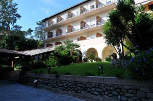 a large white building with a garden in front of it at Hotel Villa Adriana in Monterosso al Mare