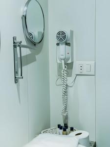 a hospital room with a mirror and a toilet at Bonaparte Hotel - Excelente Apartamento#417 in Brasilia +50 photos