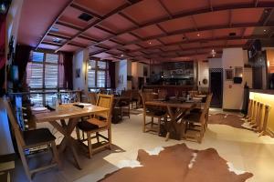 a dining room with wooden tables and chairs at Bonaparte Hotel - Excelente Apartamento#417 in Brasilia