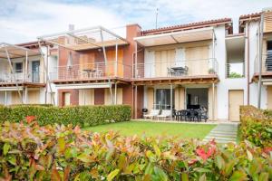 an exterior view of a house with a yard at GardalandLuxuryApartment Pool & Free Parking in Ronchi
