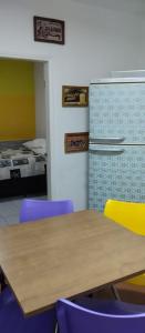 a room with a table and chairs and a bed at Yellowkits in Sao Paulo