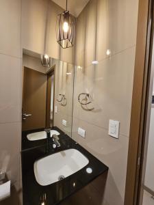 a bathroom with a sink and a mirror at Departamento de lujo en EQUIPETROL in Santa Cruz de la Sierra +6 photos