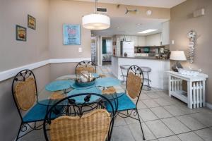 a dining room and kitchen with a table and chairs at Nautilus Unit 2310 in Fort Walton Beach