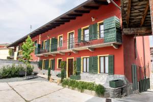 a red building with colorful windows and balconies at Agriturismo Ca' del Clat in Bagnolo Piemonte