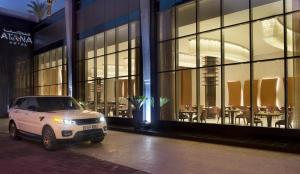 a white van parked in front of a building at Atana Hotel in Dubai
