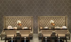a dining room with a table and chairs with candles at Atana Hotel in Dubai