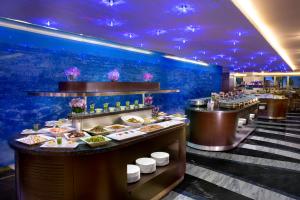 a buffet line with plates of food in a restaurant at Atana Hotel in Dubai