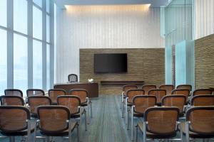 a conference room with chairs and a flat screen tv at Atana Hotel in Dubai