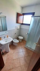 a bathroom with a sink and a toilet and a shower at La Rondine in Guardistallo +16 photos