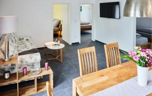a living room with a table and chairs and a couch at Pet Friendly Apartment In Attendorn in Attendorn