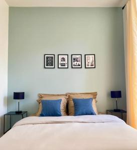 a bedroom with a bed with three pictures on the wall at Au pied de la Cathédrale de Bourges in Bourges