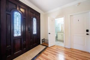 an empty hallway with a wooden door with a window at 17-19ppl BTW Dsny Hllywd GarageParking Yard Grill in Monterey Park +59 photos